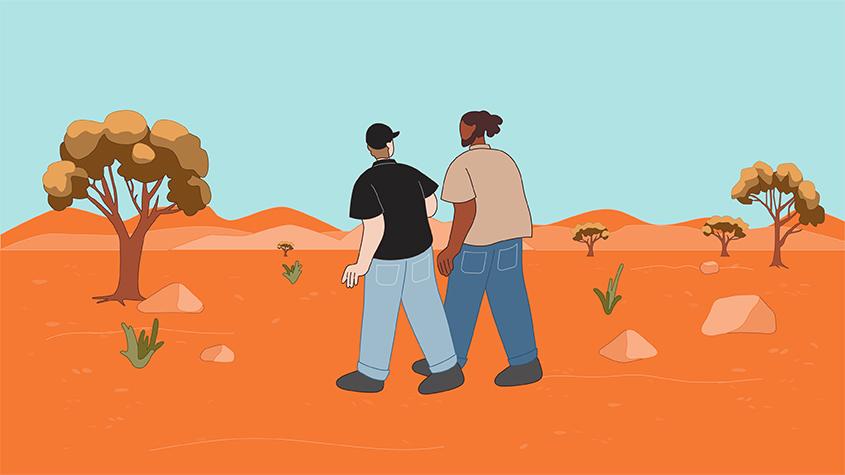 Indigenous man and non-Indigenous man walking together and talking in desert country